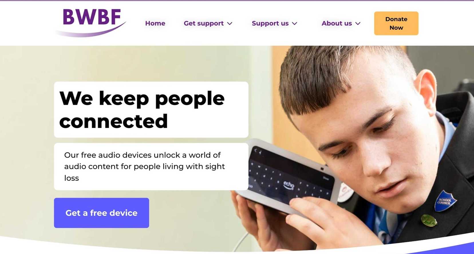 A picture of the home page of BWBF's website, with accessibility controls, site menu and a picture of a young man holding an Alexa Echo Show device