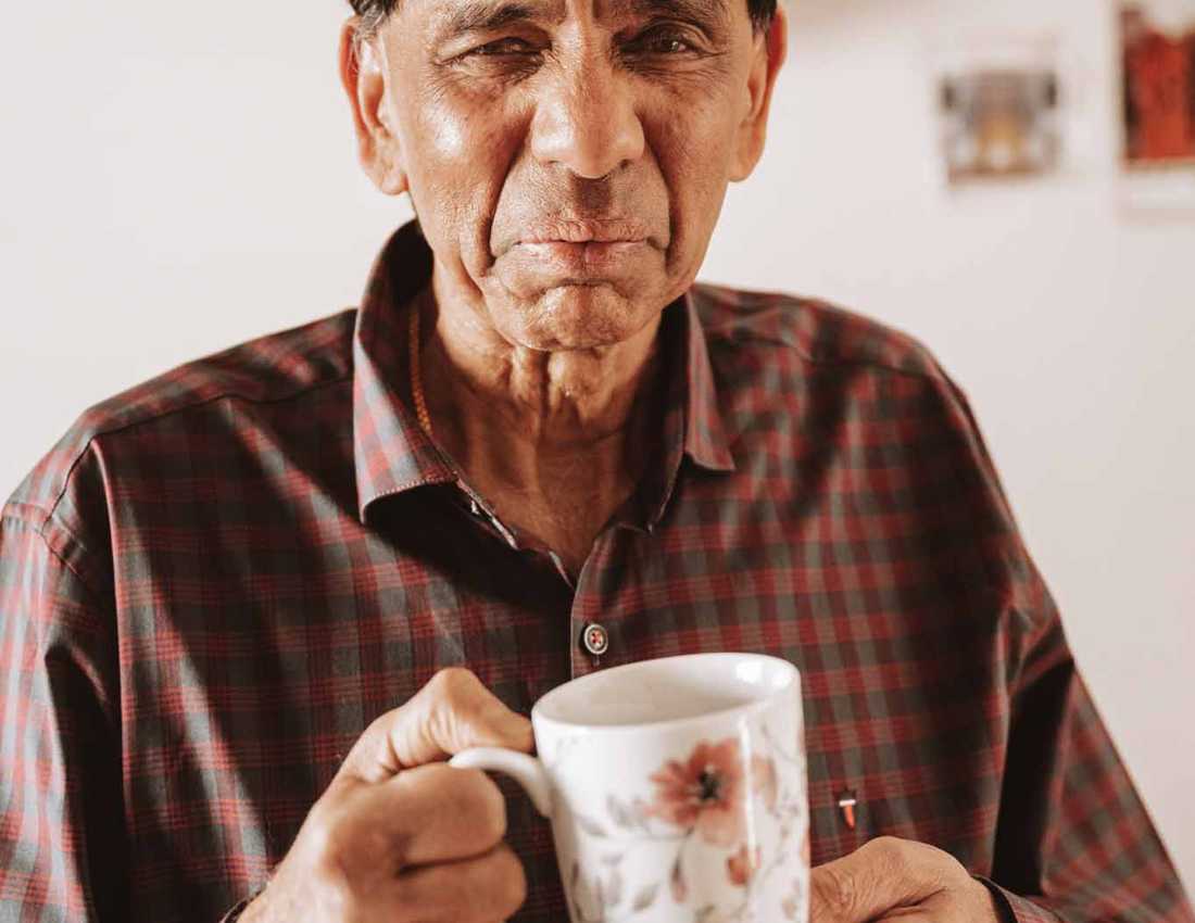 BWBF service user Krishna is in his kitchen with a cup of tea.